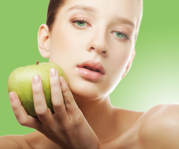 Head shot of woman holding apple