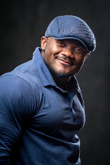 Head and shoulders portrait of smiling young african american man. Black male smiles to the camera in fashion clothes.