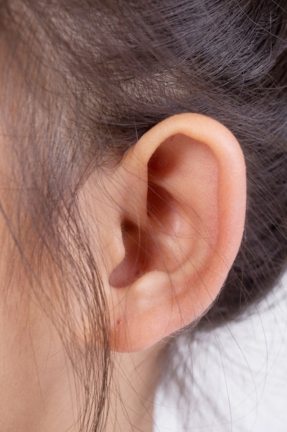 Head with asian girl ear and hair close up