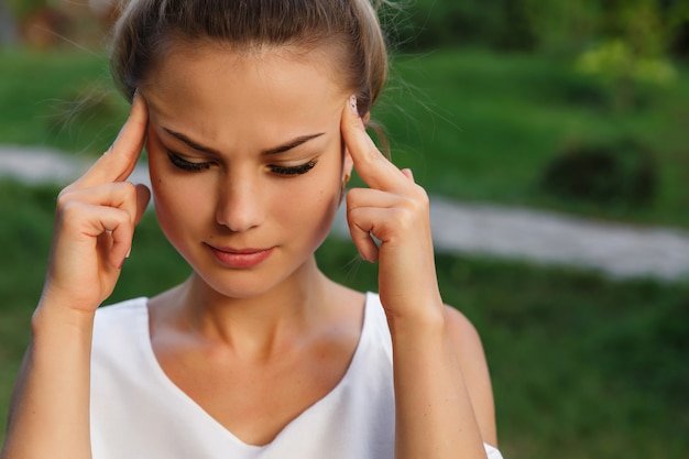 Headache of woman, head pain and stress or depression concept. Depressed girl.