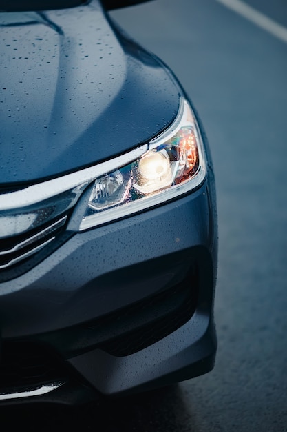 Headlight of modern prestigious black car close up. Close up photo of modern car, detail of headlight.