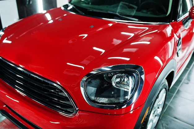 Headlights and hood of sport red car in garage