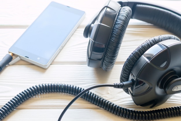 Headphones and mobile phone on a white background