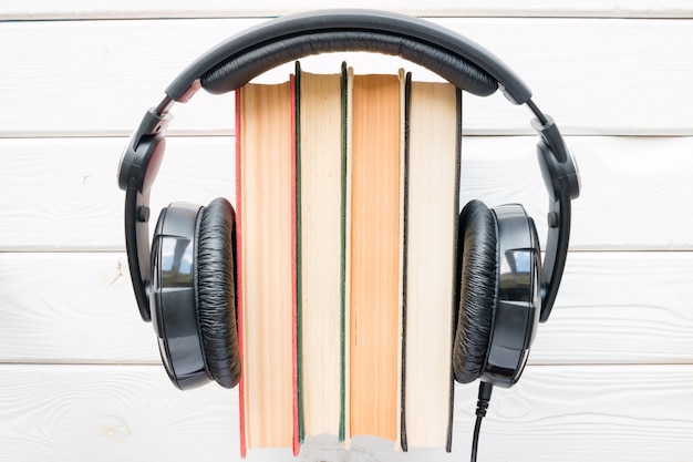 Headphones on vintage books on a white background