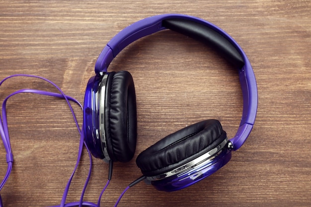 Headphones on wooden background