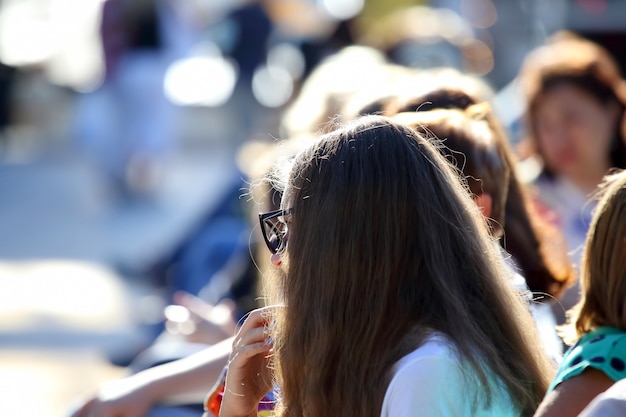 Heads of people sitting next to each other in blurred form