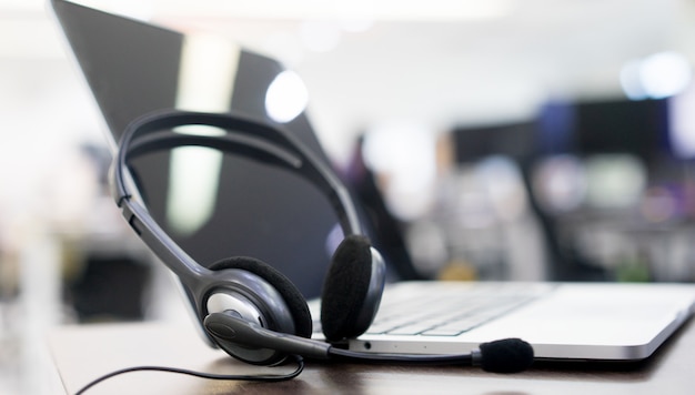 Photo headset devices at office desk for customer service support concept