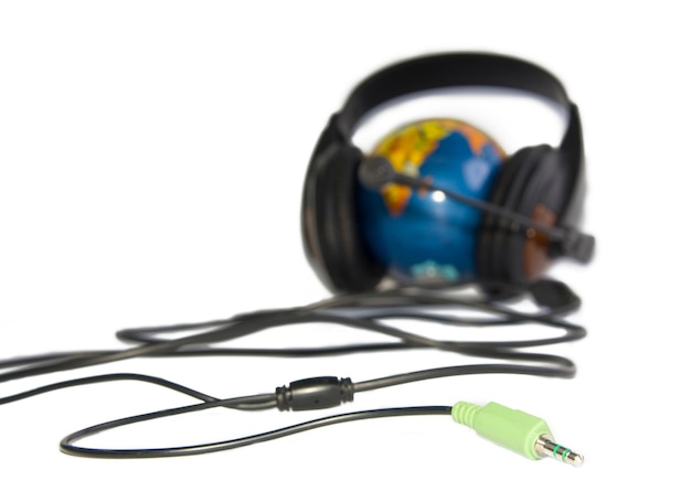 Headset on world globe with cable isolated