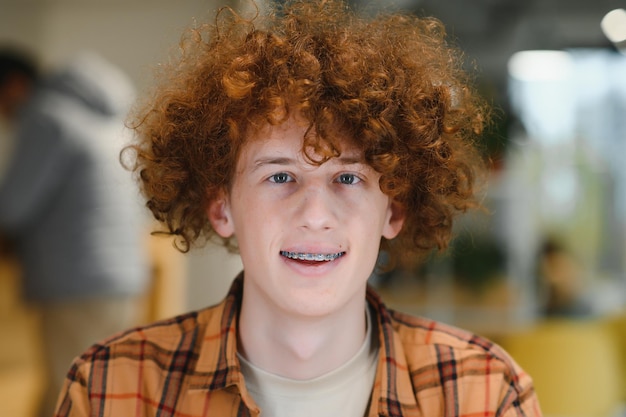 Headshot of happy redhead man smiling excited at camera