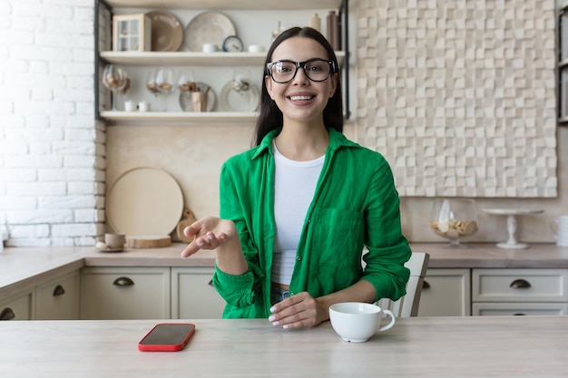 Photo headshot portrait screen view of smiling young woman sit at home talk on video call with friend or