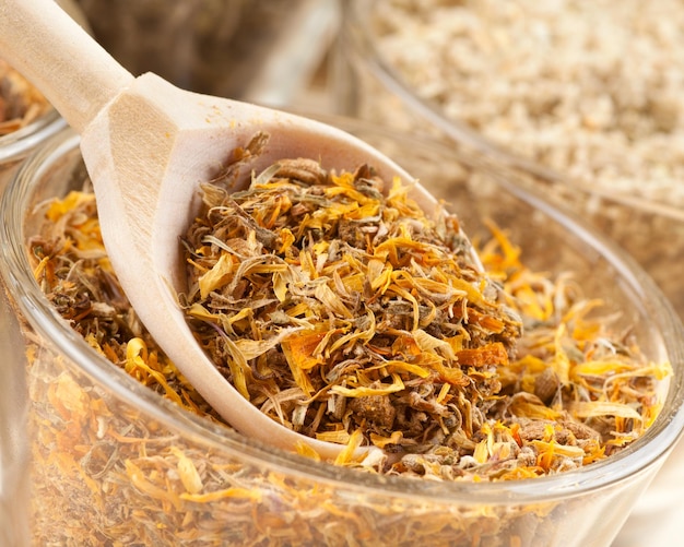 Healing herbs in wooden spoon closeup