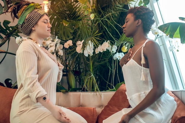 Healing session. A healer working with a dark-skinned woman