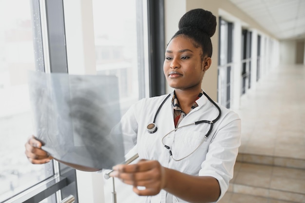 Healt and medicine concept  smiling female doctor studying xray