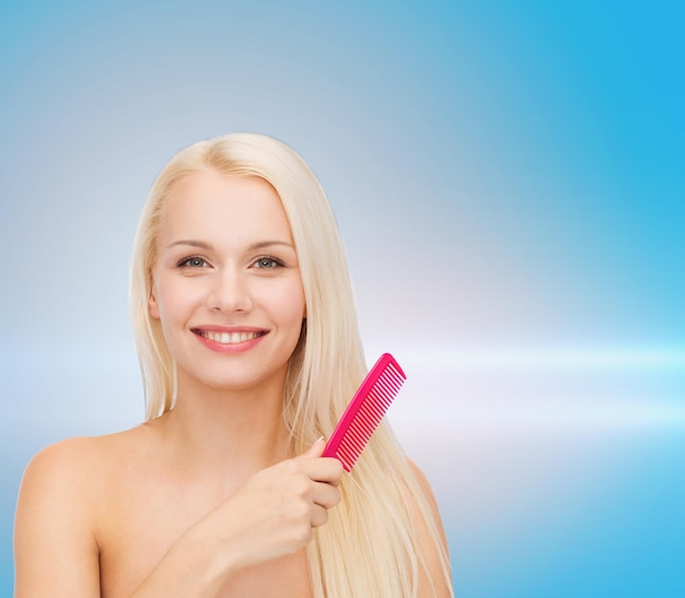 health and beauty concept - beautiful woman with long hair and brush