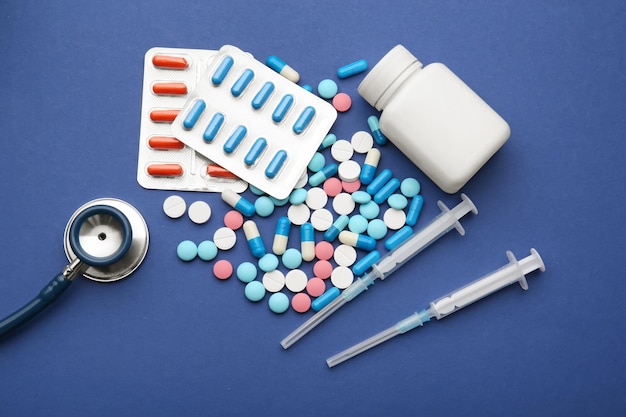 Health care concept Composition with pills and medical stuff on blue background