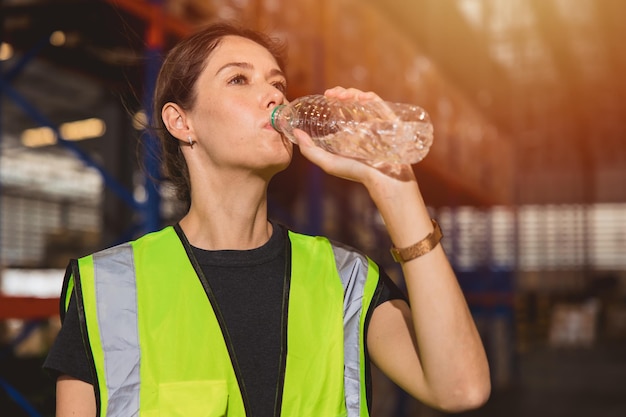 Health care woman worker drinking clean water while working in hot place for refresh and personal healthy