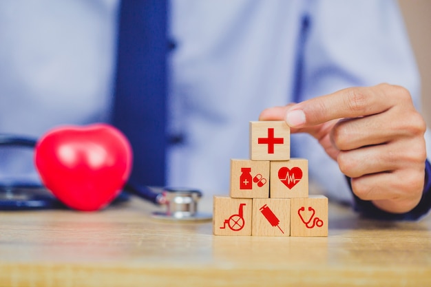 Health Insurance Concept,hand arranging wood block stacking with icon healthcare medical.