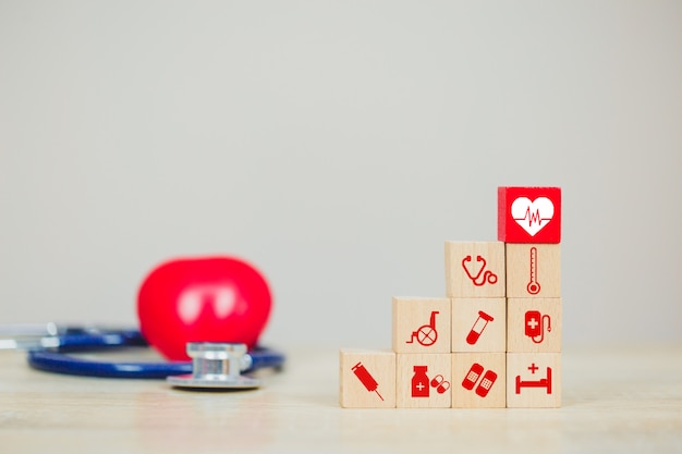 Health Insurance Concept,hand arranging wood block stacking with icon healthcare medical.