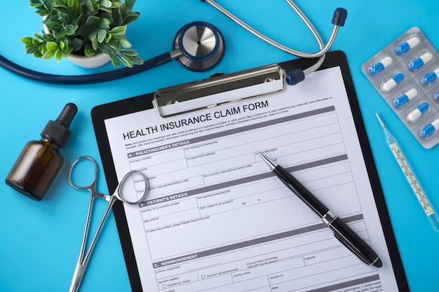 Health insurance form on blue doctor desk