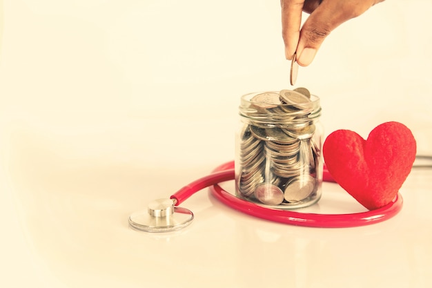 Health  insurance and Medical Healthcare heart disease concept ,  red heart shape with stethoscope , financial healthcare