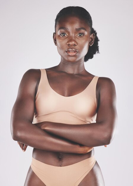 Health wellness and portrait of a black woman in underwear standing in a studio with a natural slim body Beauty natural and healthy African woman model with body care isolated on gray background