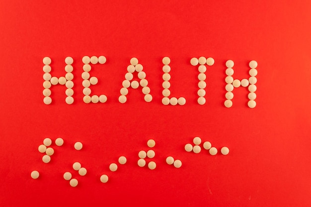 Health word written with pills of supplement