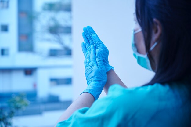 Health worker applauding from the balcony