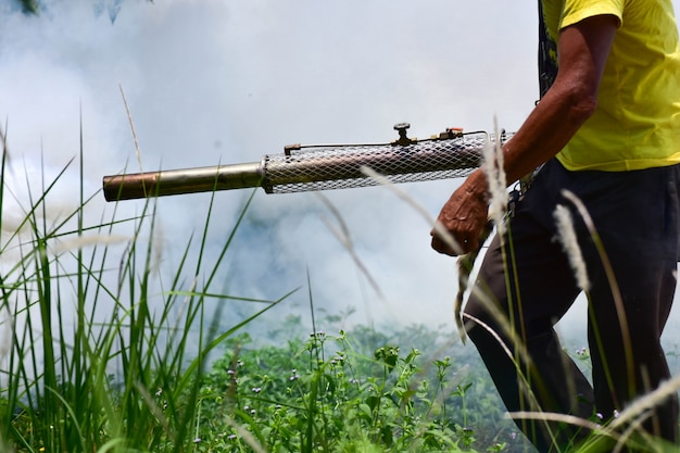 Health worker  Fumigation fogging mosquitoes carriers of dengue Zika Virus or Malaria.