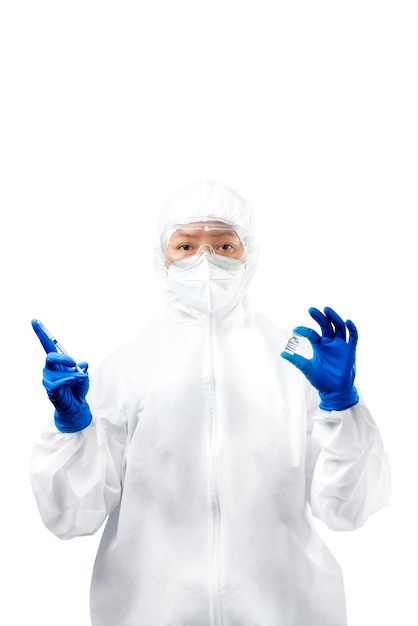 Health worker woman with a protective suit and gloves holding covid 19 vaccines isolated over white background