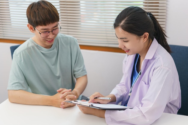 Healthcare concept Female doctor give advice and writing prescription to patient in clinic