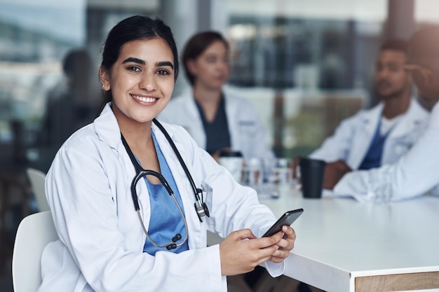 Healthcare doctor and woman with smartphone in break for chatting social media or networking Medical people female employee and mobile for texting connect and conversation online with tech