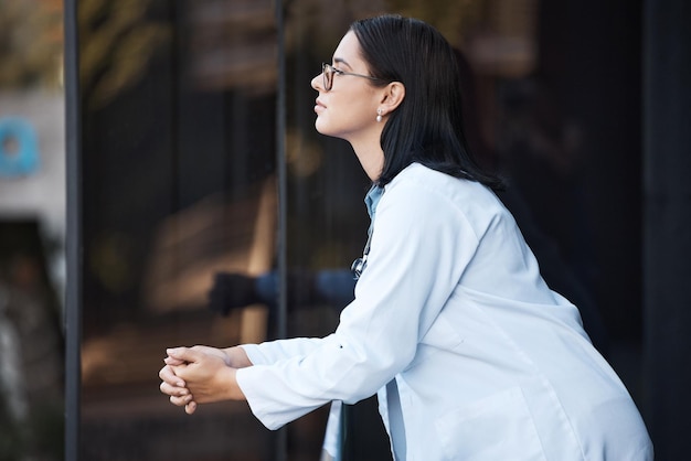 Healthcare idea and balcony with a doctor woman thinking while working at the hospital for medical or insurance Health treatment and contemplation with a female medicine professional at work