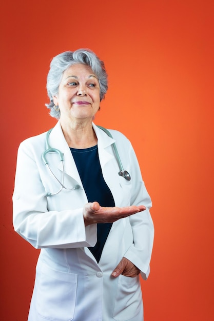 Healthcare - Mature Brazilian Doctor or Veterinarian Woman With Stethoscope Isolated on Orange