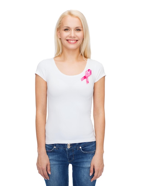 Photo healthcare and medicine concept - smiling woman in blank t-shirt with pink breast cancer awareness ribbon