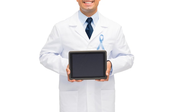 healthcare, people and medicine concept - close up of smiling male doctor in white coat with sky blue prostate cancer awareness ribbon holding tablet pc computer