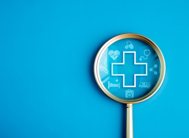 Healthcare service hospital website online search wellness plan and insurance concept Health care and medical element icon symbols in magnifying glass lens on blue background with copy space