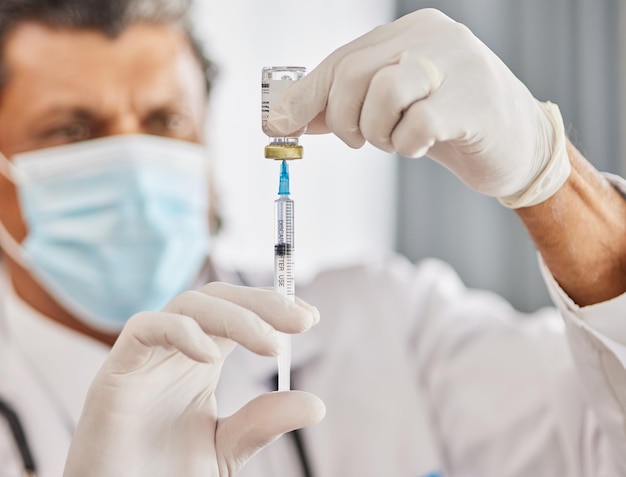 Healthcare vaccine and closeup of a doctor with a needle for a flu cold or allergy treatment Professional injection vial and zoom of male medical worker with a vaccination syringe in a clinic