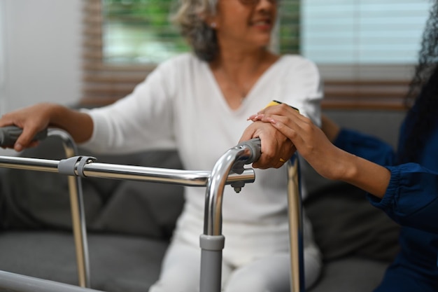 Healthcare worker or caregiver holding hands with a senior woman Elderly healthcare and Home health care service concept