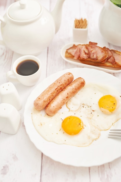 Healthly food. Continental breakfast in hotel room or bed. Fried eggs with sausages. Cup of coffee. Menu template. Cookery. Cooking. Romantic french or rural breakfast on Valentine.