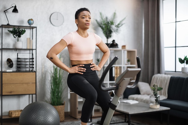 Healthy athletic female doing cardio on stationary bike