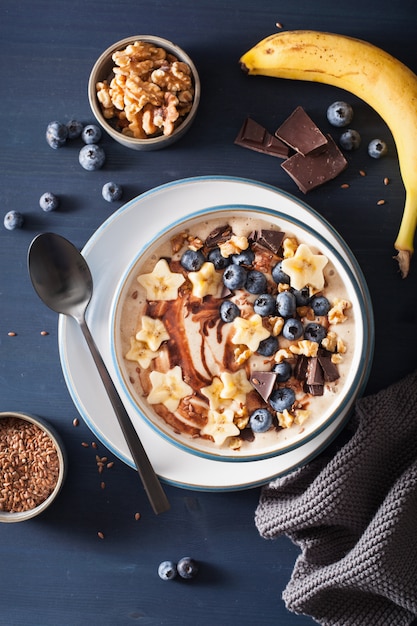 Healthy banana smoothie bowl with blueberry chocolate walnuts