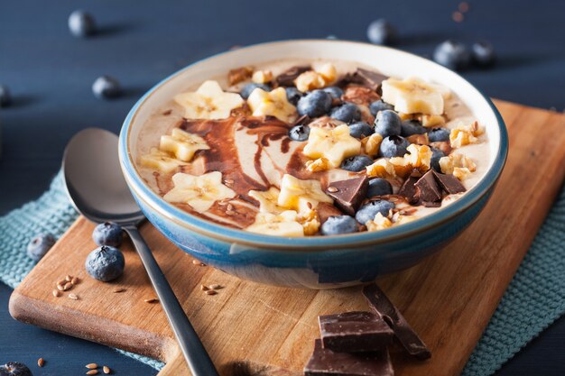 Healthy banana smoothie bowl with blueberry chocolate walnuts