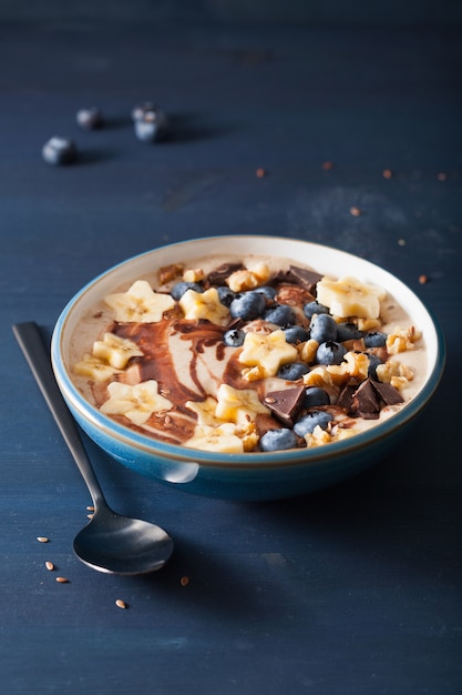 Healthy banana smoothie bowl with blueberry chocolate walnuts