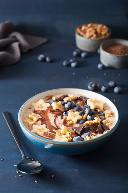 Healthy banana smoothie bowl with blueberry chocolate walnuts