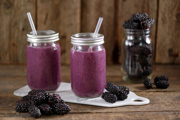 Healthy blackberry smoothie with natural yogurt and honey in a glass jar