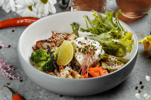 Healthy bowl quinoa salad with tuna broccoli avocado on wooden rustic table top view