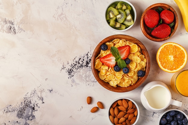 Healthy breakfast - bowl of corn flakes, berries and fruit