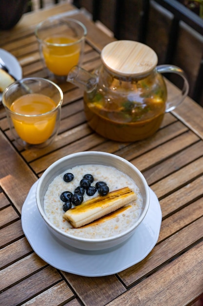 Healthy breakfast Breakfast with sea buckthorn tea oatmeal porridge and cottage cheese fritters