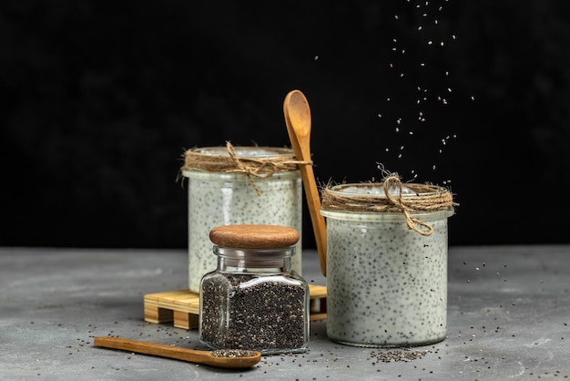 Healthy breakfast Chia seed pudding Yogurt with chia seeds healthy superfood Cottage cheese smoothie in glass jars place for text