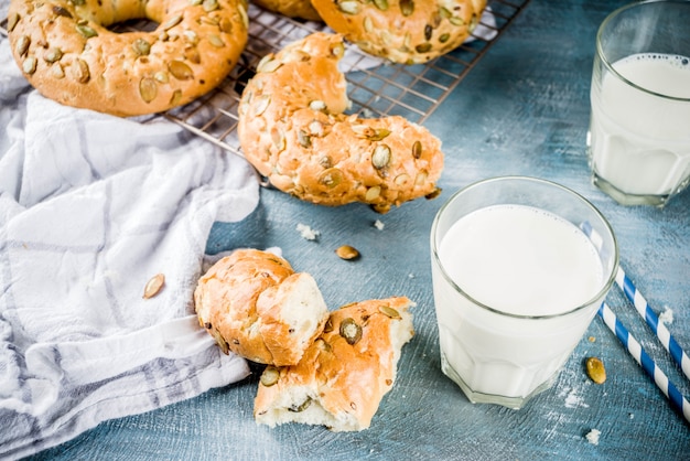 Healthy breakfast concept, home made cereal bagels with milk glass